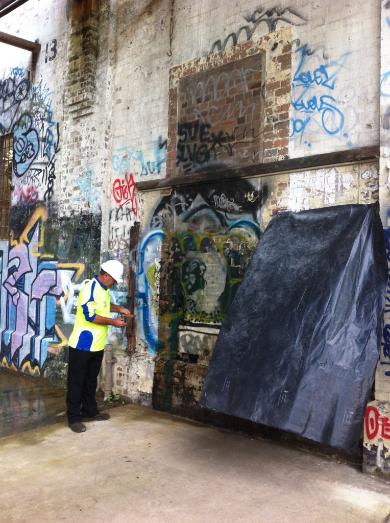 Inspecting A Grafitied Wall. Lead Paint Removal